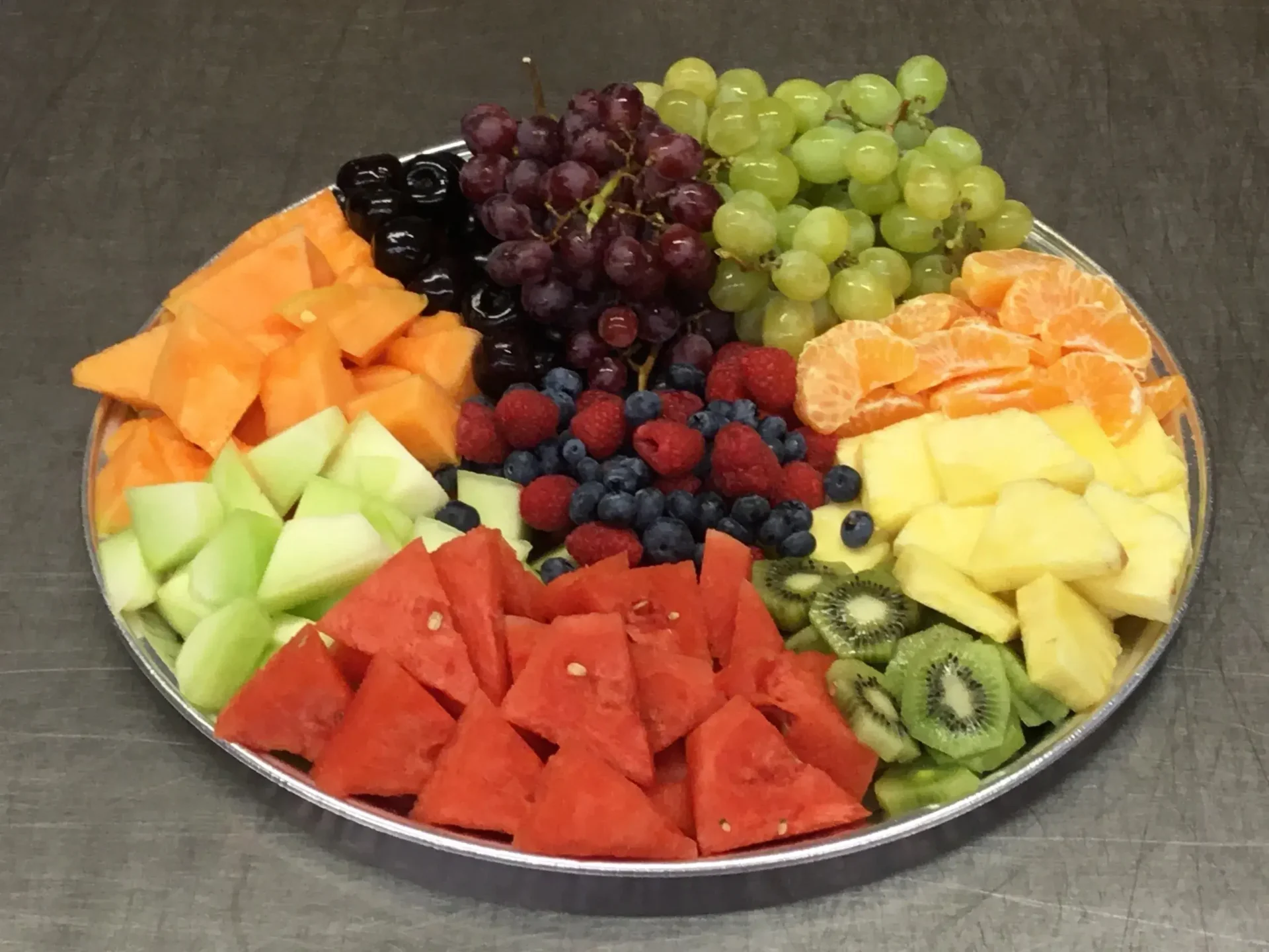 A platter of fruit is shown on the table.